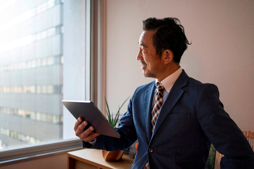 side-view-business-man-holding-tablet-1024x683(1).jpg