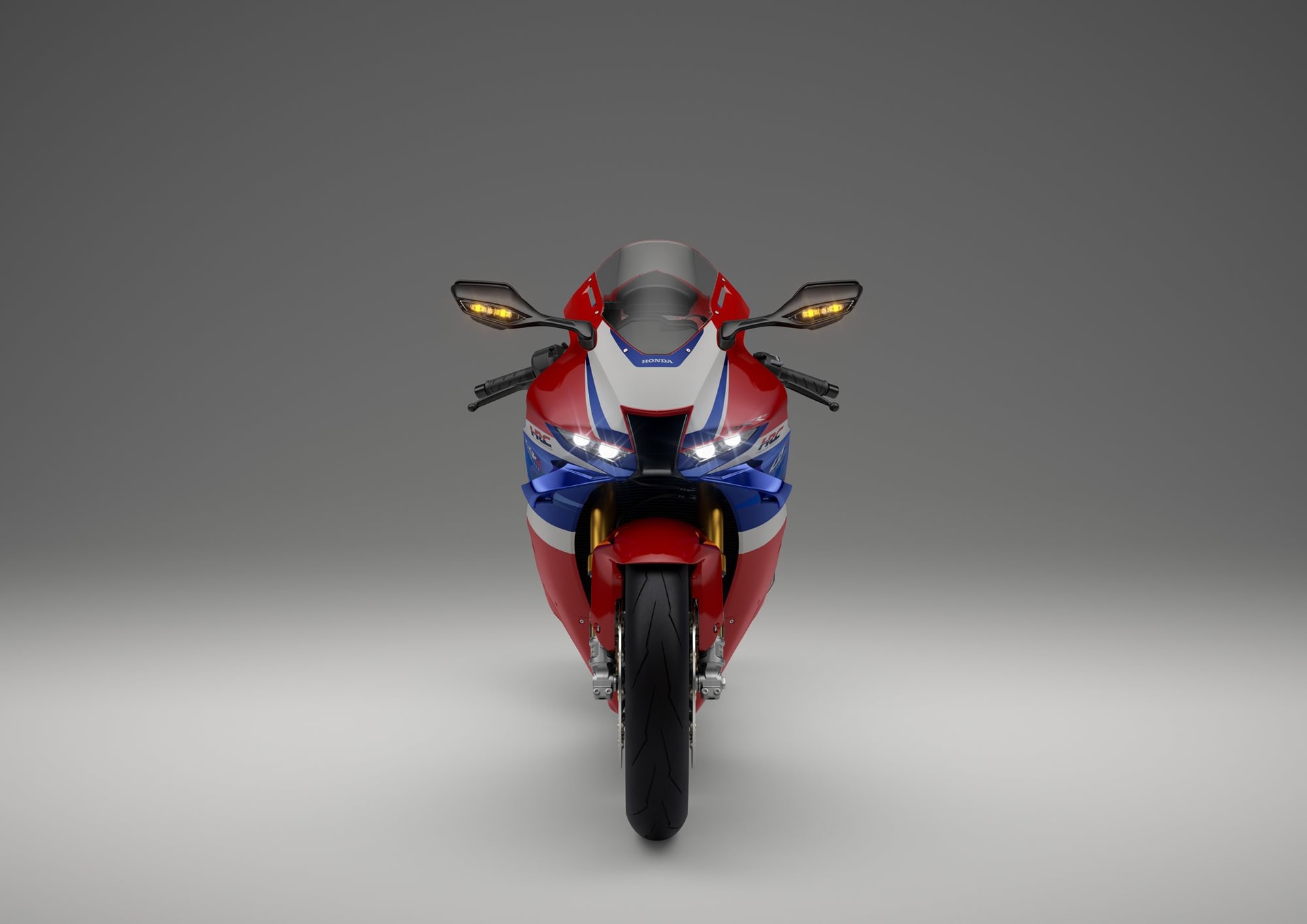 2024-cbr1000rr-r_studio_grand_prix_red_sp_front_with_light_on_high_beam_s.jpg