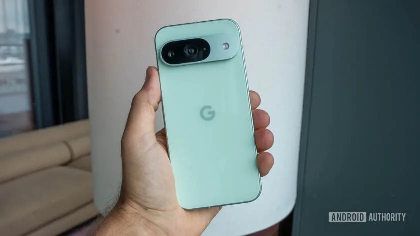 google-pixel-9-in-wintergreen-color-held-in-persons-left-hand-showing-back-840w-472h.jpg.jpg