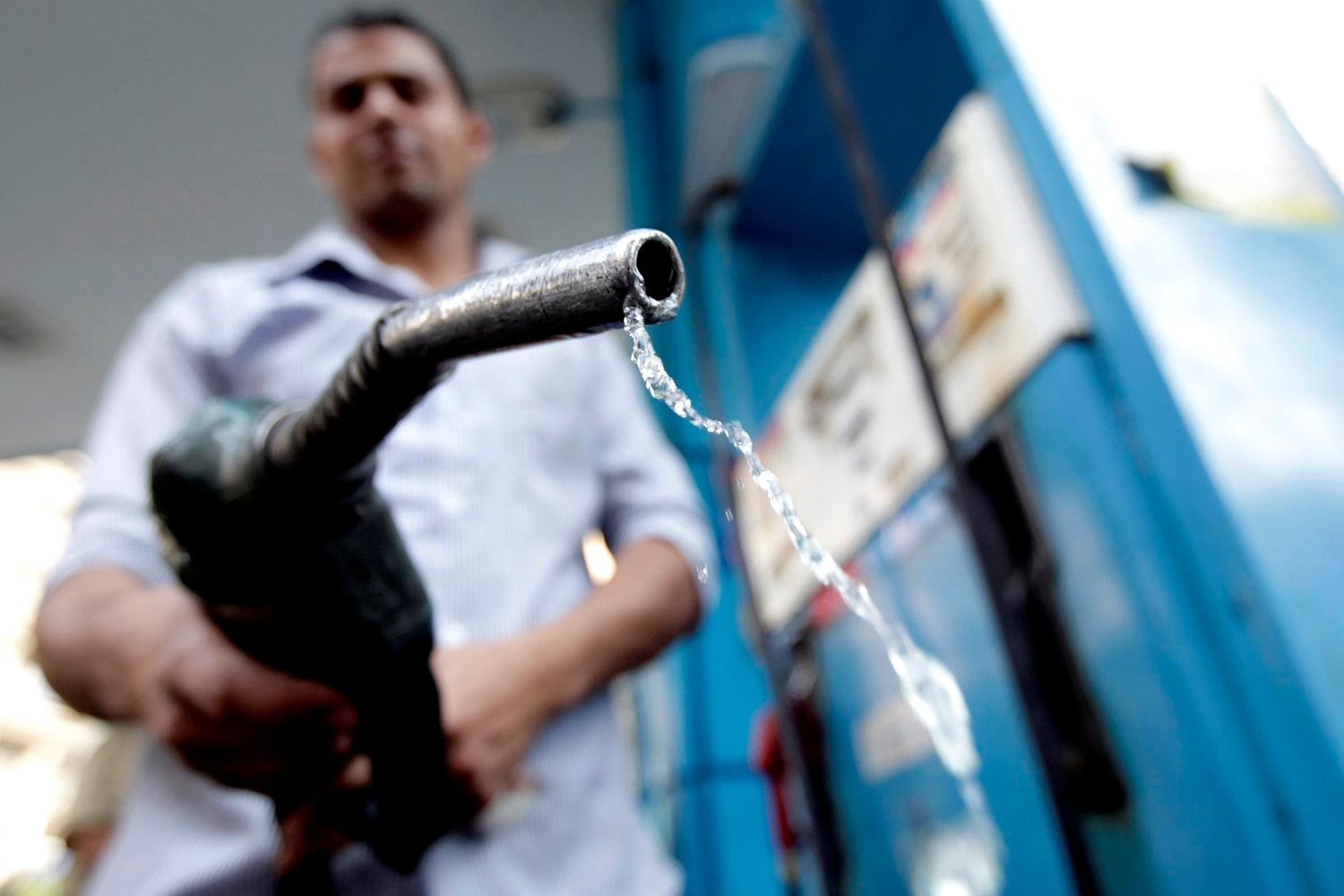 a-worker-holds-up-a-fuel-pump-nozzle-after-filling-up-the-tank-of-a-car-at-a-petrol-station-in-cairo-anh-reuters-1-5845.jpg